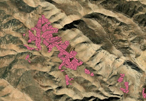 Parcel polygons outlined in pink over mountainous terrain